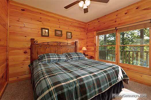 King bed in first floor bedroom at Logged Out, a 3 bedroom cabin rental located in Pigeon Forge