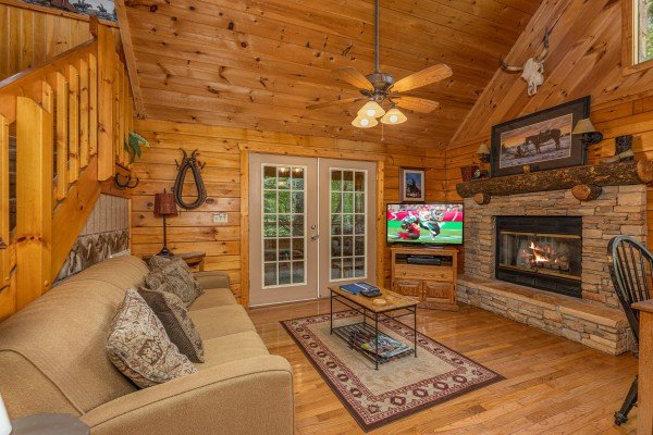 Living room fireplace at Hooked on Cowboys Lodge, a 2 bedroom cabin rental located in Pigeon Forge
