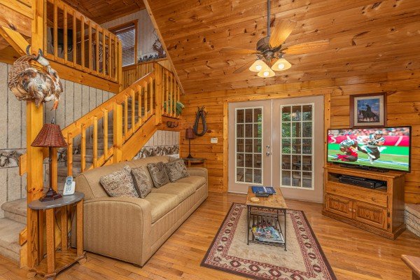 Livingroom seating and flat screen at Hooked on Cowboys Lodge, a 2 bedroom cabin rental located in Pigeon Forge