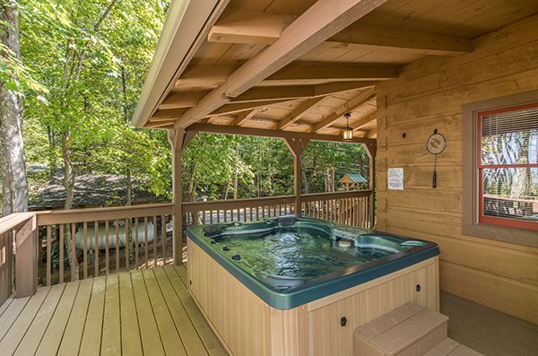 Hot tub on the deck, under cover from the elements at bearfoot adventure a 2 bedroom cabin rental located in gatlinburg