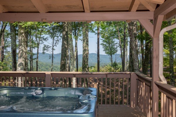 Mountain views from the hot tub on a covered deck at bearfoot adventure a 2 bedroom cabin rental located in gatlinburg