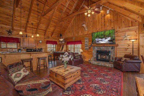 Living room and kitchen with breakfast bar at Bearfoot Adventure, a Gatlinburg Cabin rental
