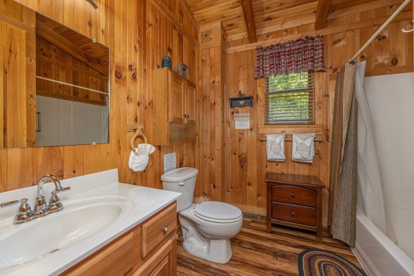 Bathroom with tub and shower at Bearfoot Adventure, a 2 bedroom cabin rental located in Gatlinburg