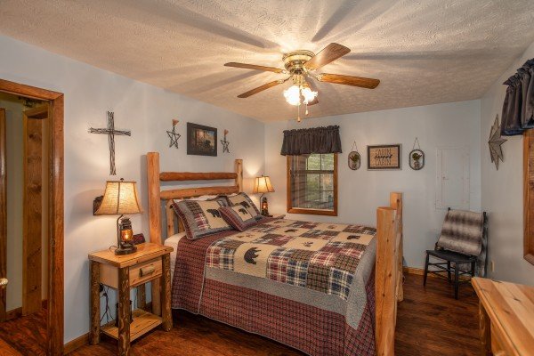 Bedroom with a queen log bed at Black Bear Holler, a cabin rental in Pigeon Forge