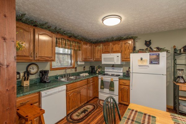 Kitchen with white appliances at Black Bear Holler, a cabin rental in Pigeon Forge