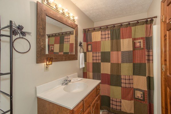 Bathroom with tub and shower at Black Bear Holler, a cabin rental in Pigeon Forge