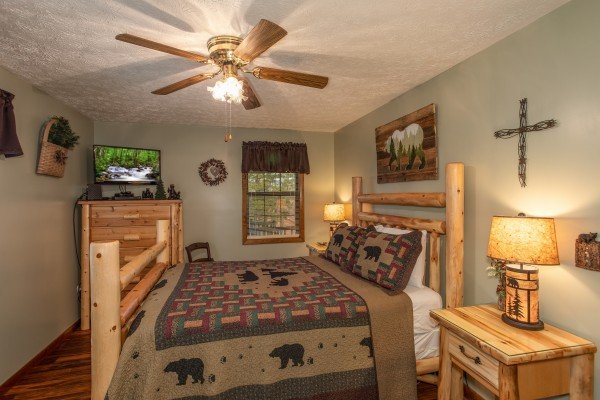 Bedroom with a queen bed, TV, and dresser at Black Bear Holler, a cabin rental in Pigeon Forge