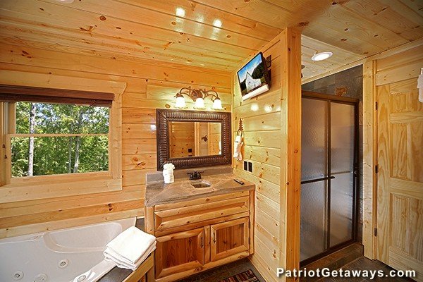 Bathroom with jacuzzi in the corner and separate shower at Incredible! A 6 bedroom cabin rental located in Gatlinburg