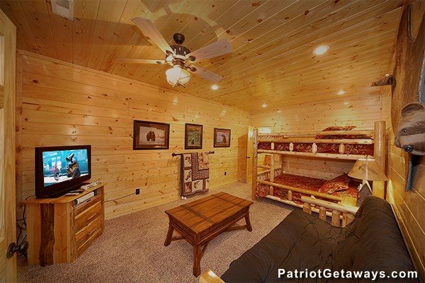 Bunk room with TV and futon at Incredible! A 6 bedroom cabin rental located in Gatlinburg