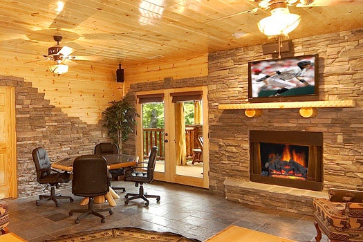 Poker table next to fireplace in the second living room at Incredible! A 6 bedroom cabin rental located in Gatlinburg