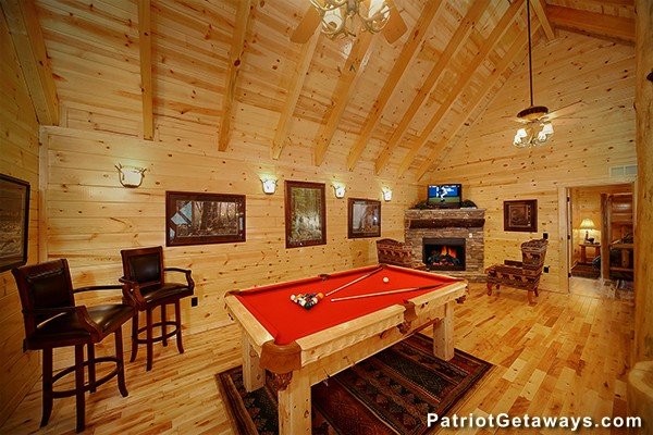 Pool table in the loft space near a fireplace and TV Incredible! A 6 bedroom cabin rental located in Gatlinburg