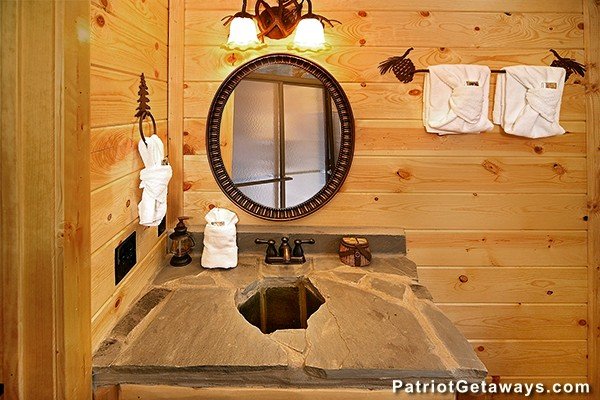 Custom stone vanity at Incredible! A 6 bedroom cabin rental located in Gatlinburg