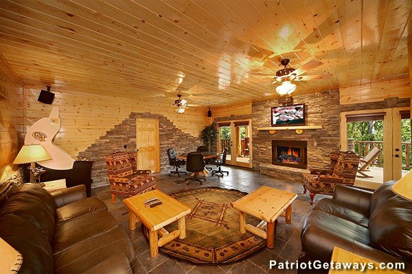 Additional living room with poker table, fireplace and TV at Incredible! A 6 bedroom cabin rental located in Gatlinburg
