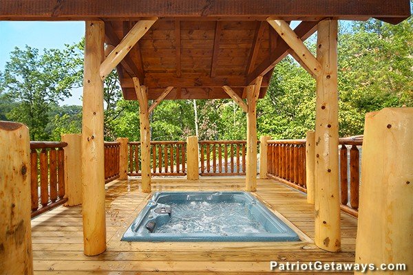 Hot tub sunken into a gazebo-style deck at Incredible! A 6 bedroom cabin rental located in Gatlinburg
