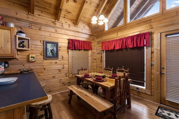 Dining table with seating for six at Bootlegger's Bounty, a 1-bedroom cabin rental located in Pigeon Forge