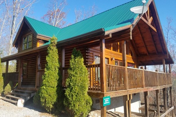 Cabin entrance from the gravel driveway at Bootlegger's Bounty, a 1-bedroom cabin rental located in Pigeon Forge