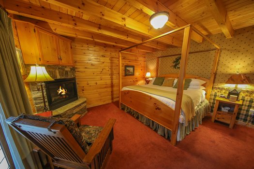 King bedroom with a fireplace at Fox n' Socks, a 3-bedroom cabin rental located in Pigeon Forge