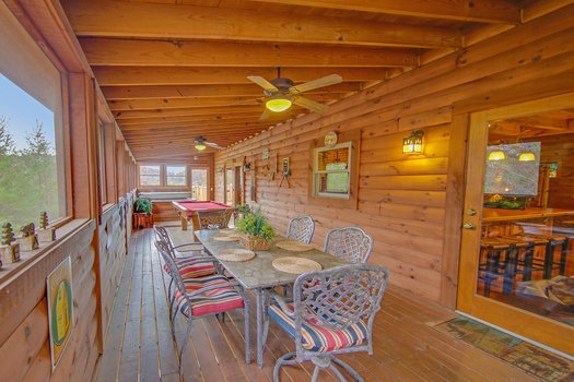 Dining space for six on the screened in porch at Fox n' Socks, a 3-bedroom cabin rental located in Pigeon Forge