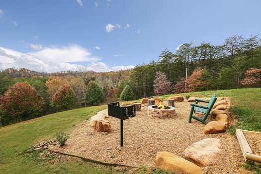 Charcoal grill, fire pit, and seating at Fox n' Socks, a 3-bedroom cabin rental located in Pigeon Forge