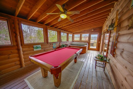 Pool table on the screened-in, covered deck at Fox n' Socks, a 3-bedroom cabin rental located in Pigeon Forge