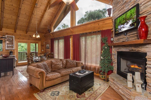 Living room with a fireplace and TV at Laid Back, a 2 bedroom cabin rental located in Pigeon Forge