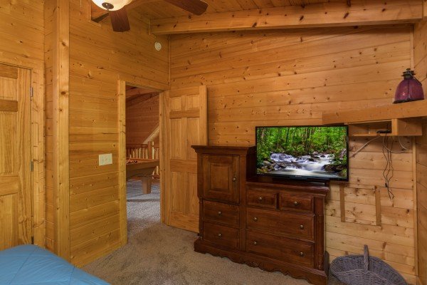 Dresser and TV in a bedroom at Laid Back, a 2 bedroom cabin rental located in Pigeon Forge
