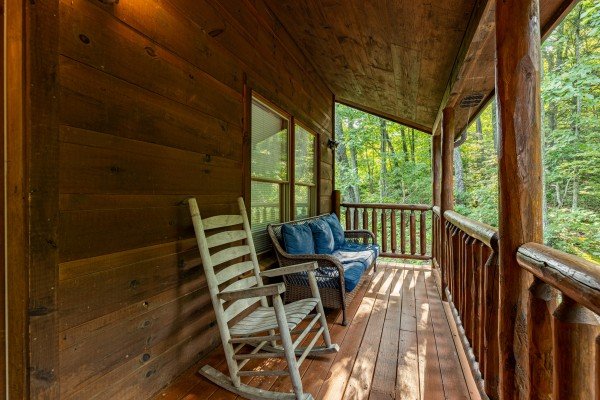 Front porch seating at Tip Top View, a 3 bedroom cabin rental located in Pigeon Forge