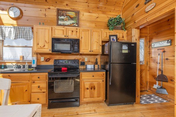 Stove, microwave and fridge at Tip Top View, a 3 bedroom cabin rental located in Pigeon Forge
