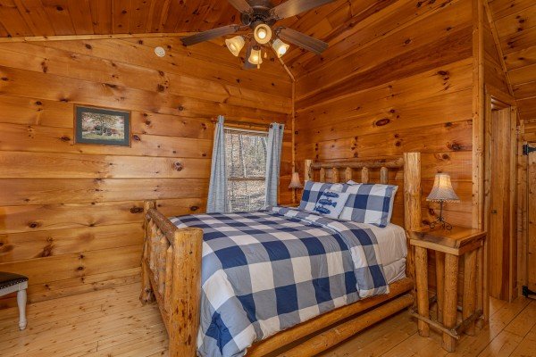 Bedroom with a log bed and two night stands at Tip Top View, a 3 bedroom cabin rental located in Pigeon Forge