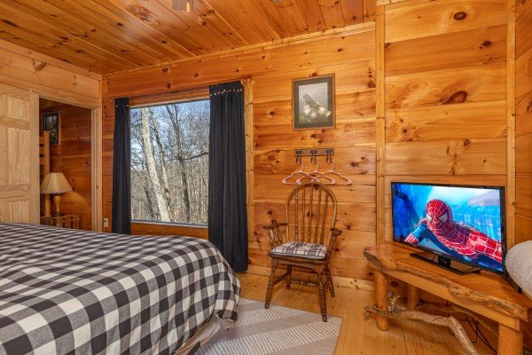 TV and chair in a bedroom at Tip Top View, a 3 bedroom cabin rental located in Pigeon Forge