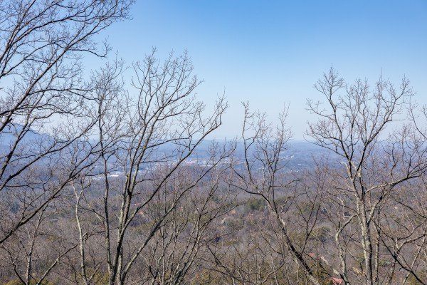 Winter view through the trees at Tip Top View, a 3 bedroom cabin rental located in Pigeon Forge