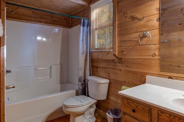 Bathroom with a tub and shower at Lincoln Logs, a 2 bedroom cabin rental located in Gatlinburg