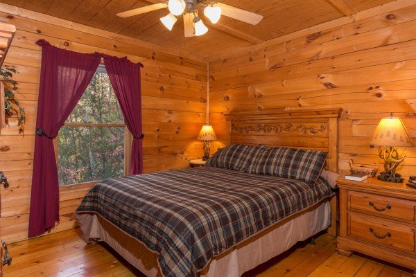 Bedroom with night stands and TV at Lincoln Logs, a 2 bedroom cabin rental located in Gatlinburg