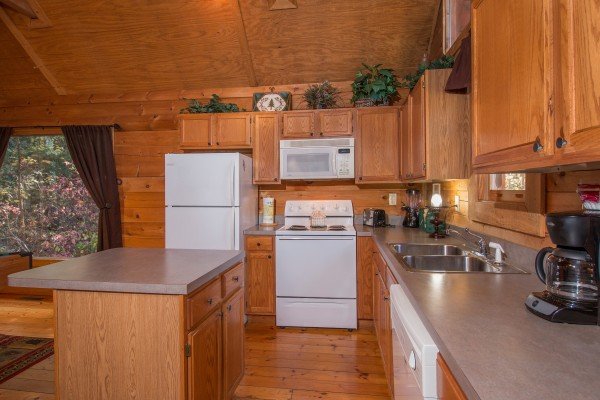 Kitchen with white appliances at Lincoln Logs, a 2 bedroom cabin rental located in Gatlinburg