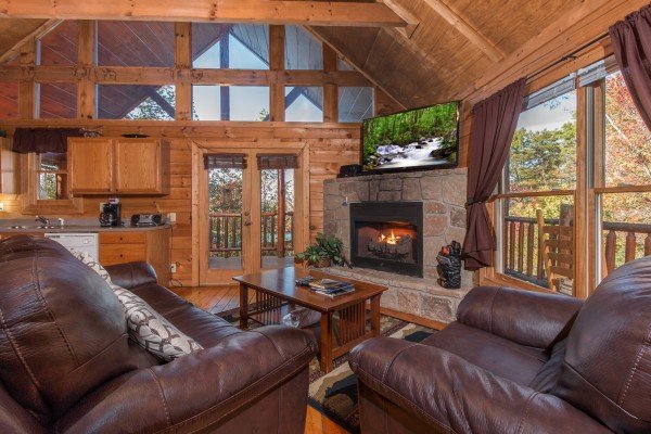 Living room with fireplace and TV at Lincoln Logs, a 2 bedroom cabin rental located in Gatlinburg 