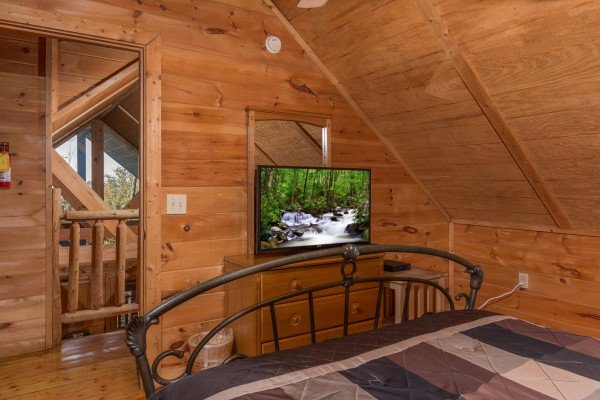Dresser, TV, and mirror in a bedroom at Lincoln Logs, a 2 bedroom cabin rental located in Gatlinburg