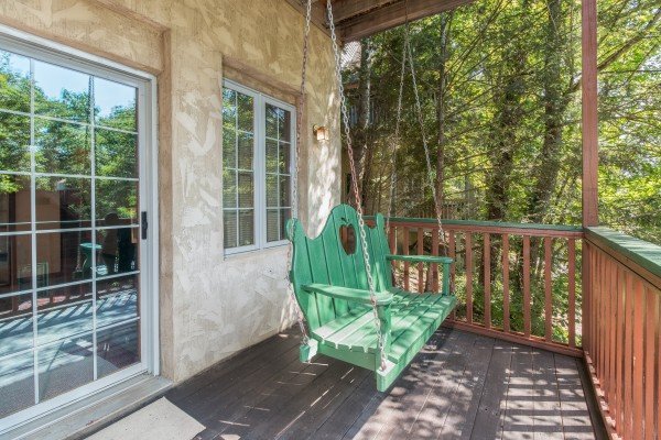 Porch swing at Ain't Misbehaven, a 1 bedroom cabin rental located in Pigeon Forge