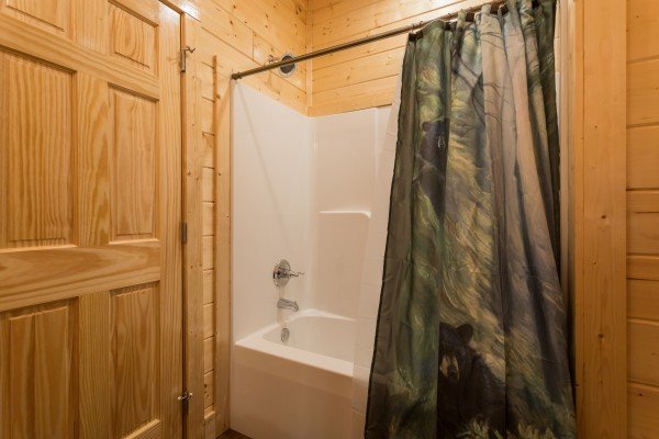Bathroom with a tub and shower at Splash Mountain Lodge a 4 bedroom cabin rental located in Gatlinburg
