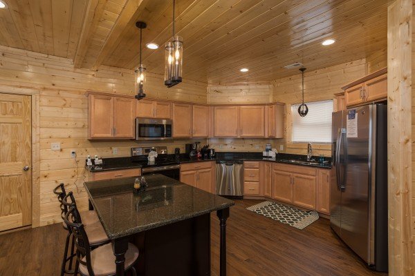 Kitchen with breakfast bar and stainless appliances at Splash Mountain Lodge a 4 bedroom cabin rental located in Gatlinburg