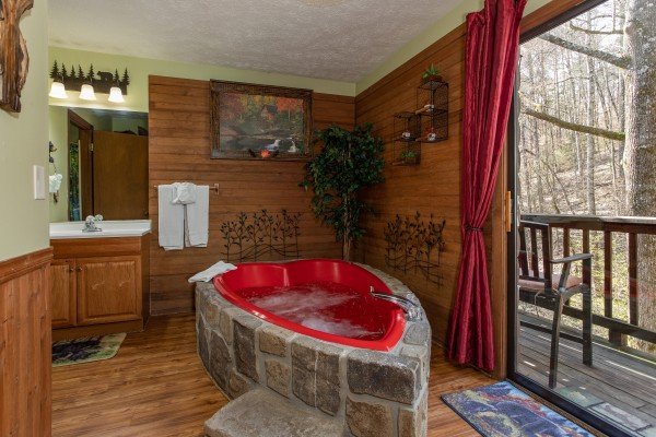Heart shaped jacuzzi tub at deck access at Bear Mountain Hollow, a 1 bedroom cabin rental located in Pigeon Forge