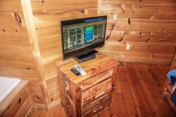 Flat screen tv in the bedroom at Deerly Beloved, a 1-bedroom cabin rental located in Gatlinburg