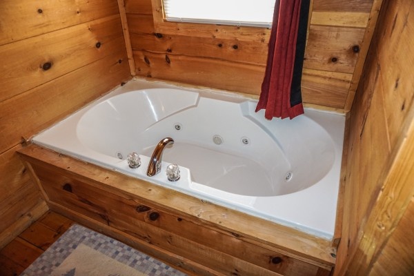Jacuzzi tub in the bedroom of Deerly Beloved, a 1-bedroom cabin rental located in Gatlinburg