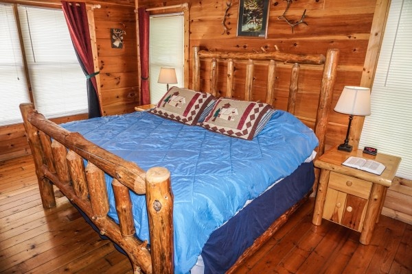 Log framed king bed at Deerly Beloved, a 1-bedroom cabin rental located in Gatlinburg