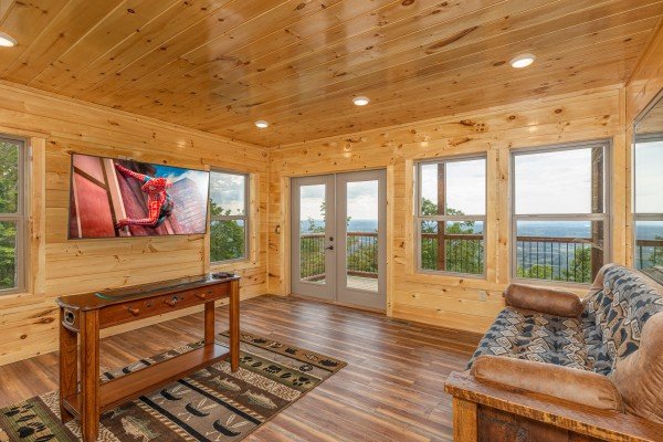 Living room with a TV and deck access at 4 States View, a 2 bedroom cabin rental located in Pigeon Forge