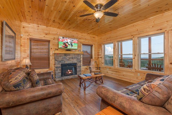 Living room with brick fireplace at The One With The View, a 4 bedroom cabin rental located in Pigeon Forge