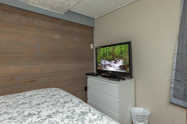 Dresser and TV in a bedroom at Terrace Garden Manor, a 13 bedroom cabin rental located in Gatlinburg