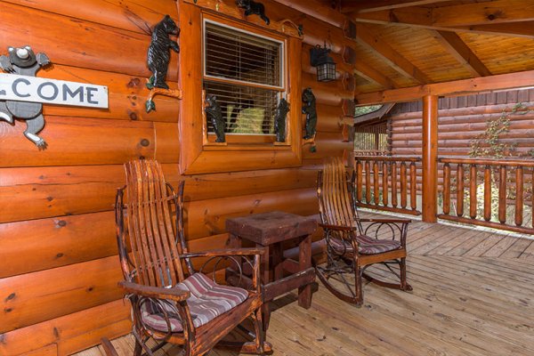 Rocking chairs on the front porch at Bearfoot Memories, a 2-bedroom cabin rental located in Pigeon Forge