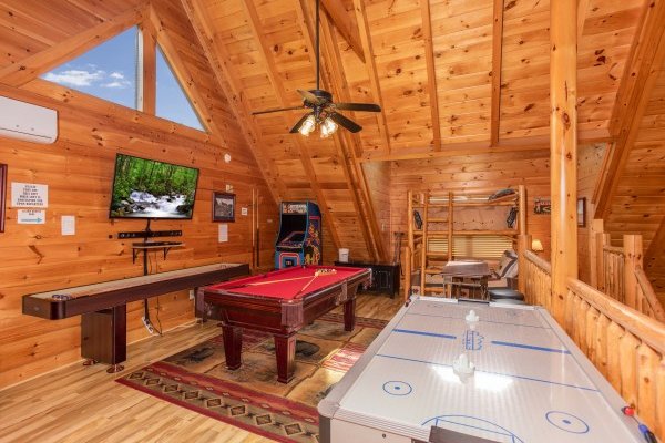 Air hockey table, pool table, and shuffle board at Bearfoot Memories, a 2-bedroom cabin rental located in Pigeon Forge
