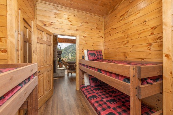Bedroom with four twin bunk beds at Black Bears & Biscuits Lodge, a 6 bedroom cabin rental located in Pigeon Forge