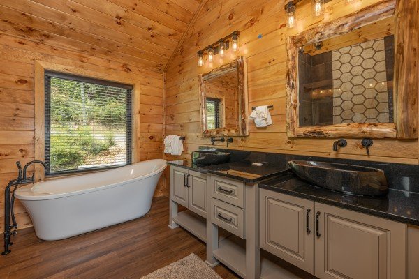 Bathroom with soaker tub and double vanity sinks at Black Bears & Biscuits Lodge, a 6 bedroom cabin rental located in Pigeon Forge